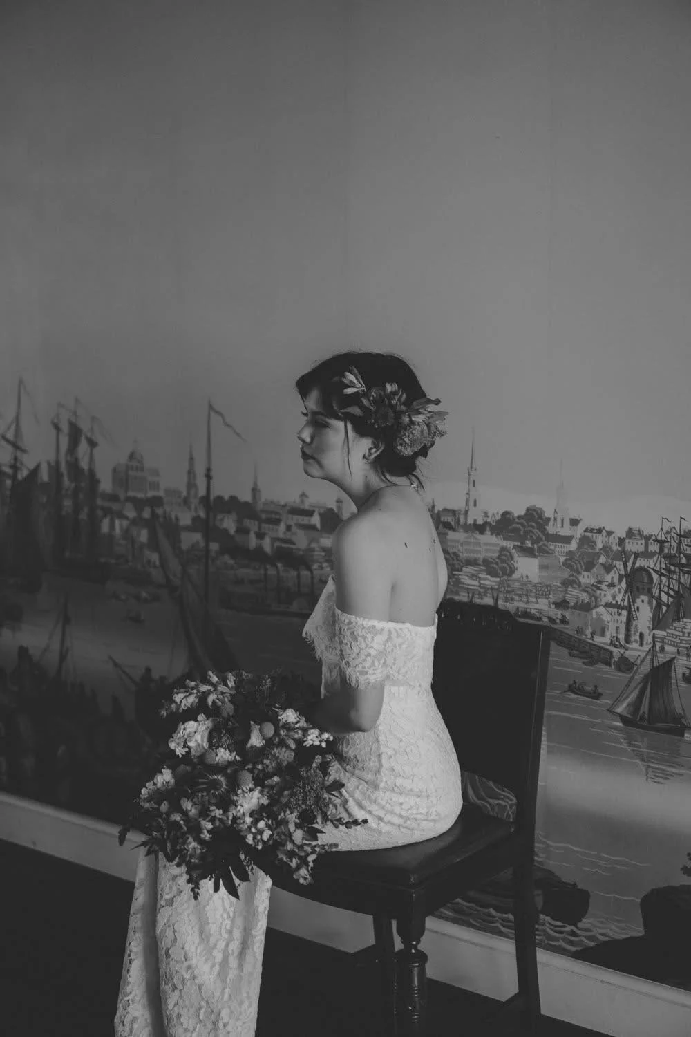 Denver bride posing with a large, colorful, fun, sustainable flower bouquet grown in Brighton colorado.