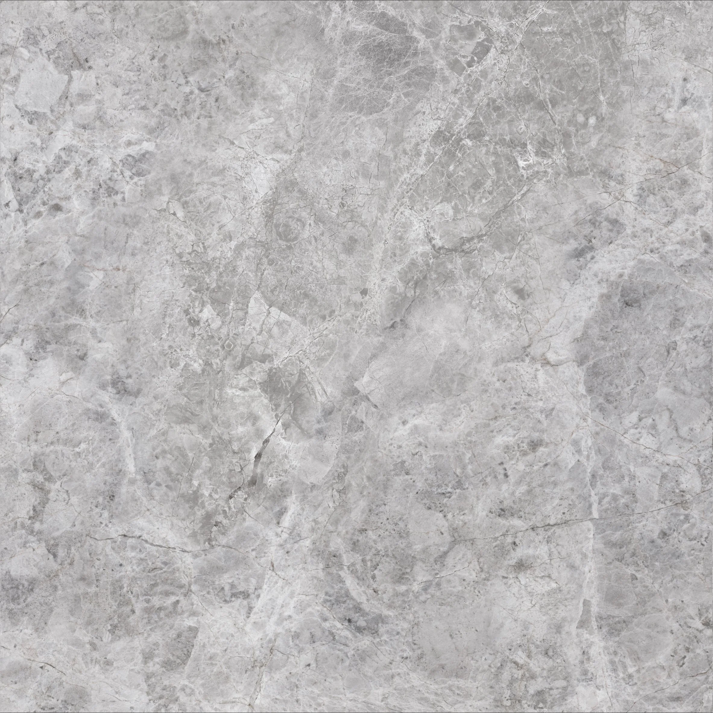Close-up of Pietra Tundra Mist marble-look porcelain tile showing layered grey tones, delicate white veining and intricate stone-inspired patterns.