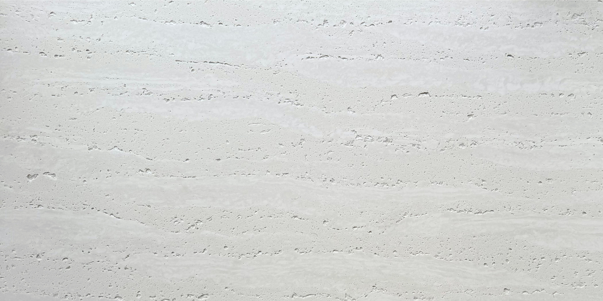 Close-up of Travertine Classico Linen travertine-look porcelain tile showing pale cream-grey tones, horizontal linear movement and distinctive natural-looking pitting.