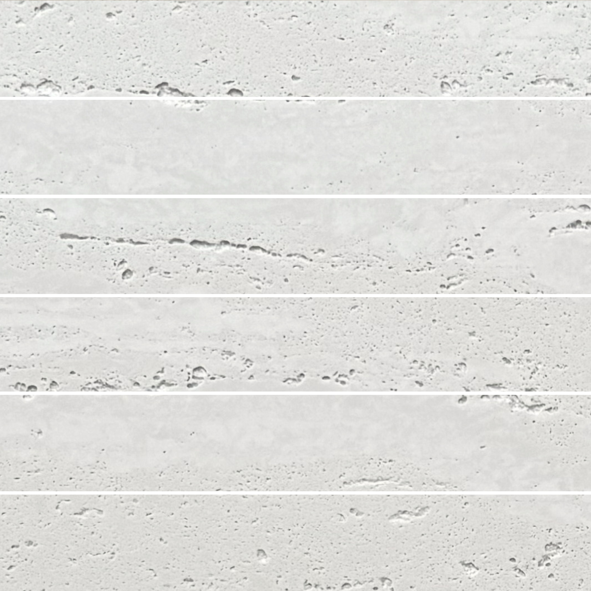 Close-up of Travertine Classico Linea Linen porcelain mosaic tiles arranged horizontally, showing pale cream-grey tones, delicate linear movement and distinctive pitting.