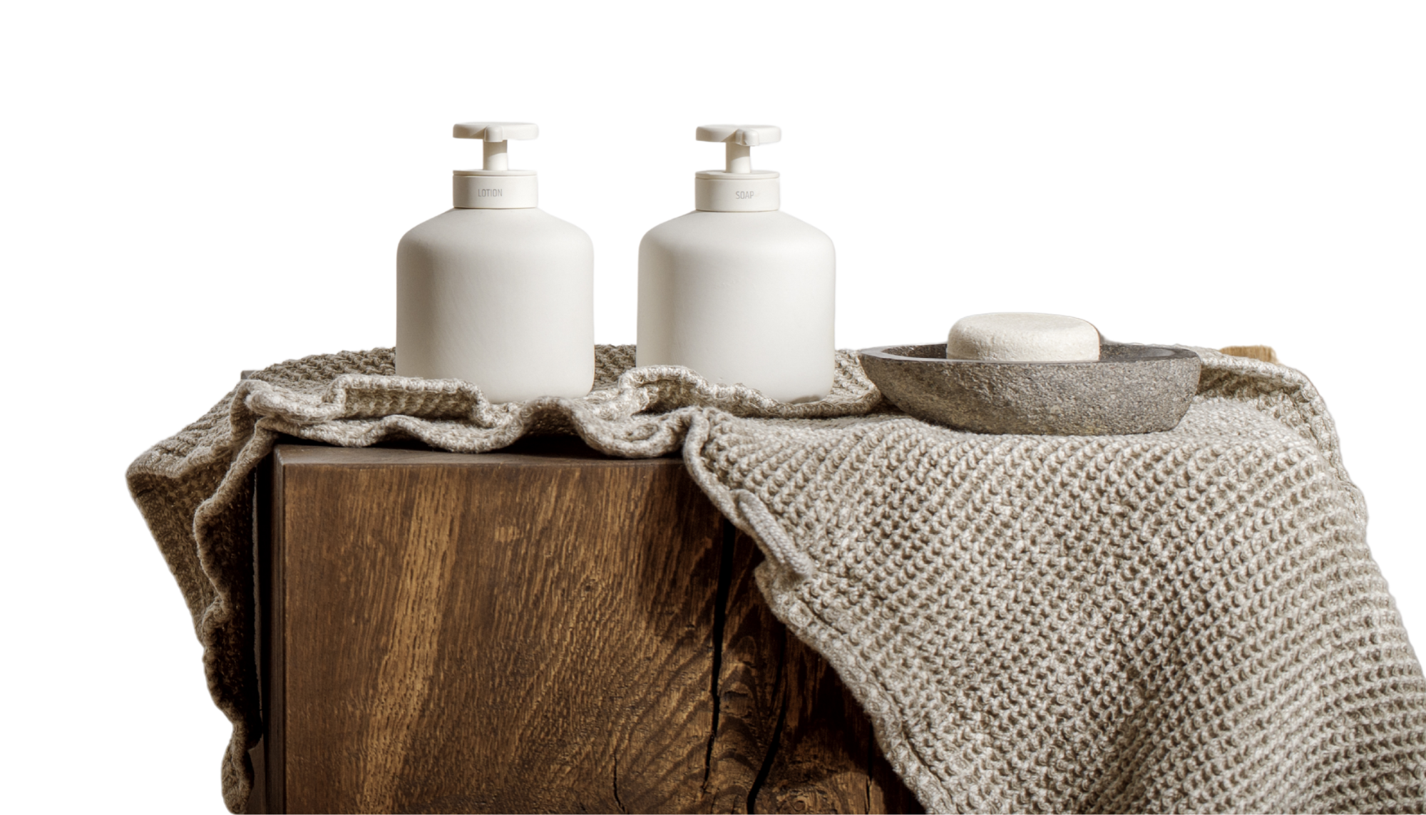 Travertine Classico Stone porcelain tile banner featuring a light grey travertine-look surface with horizontal veining and pitting, styled with a timber stool, knitted towel and soap bottles.
