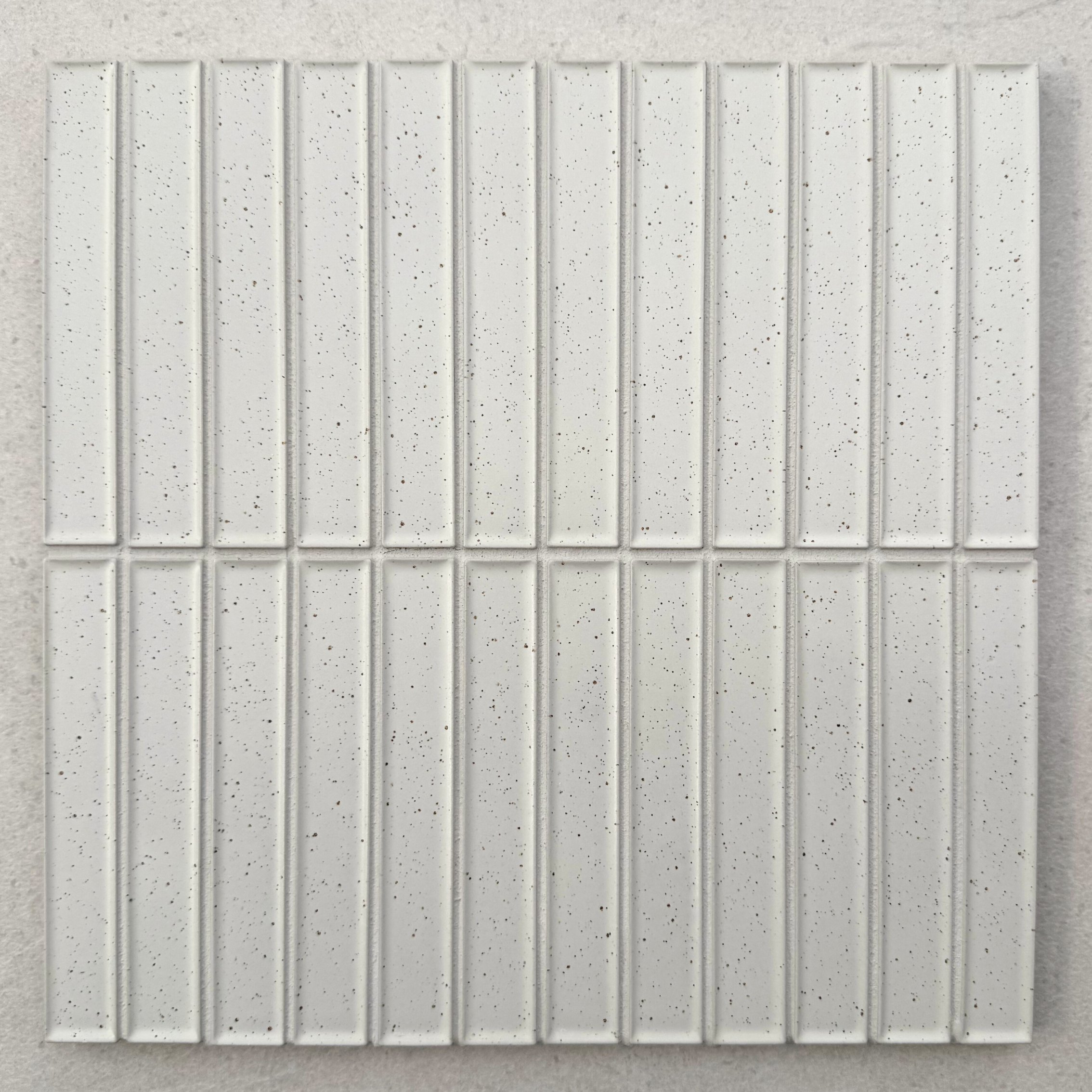 Rasa KitKat Off White porcelain mosaic tile sheet showing narrow rectangular finger tiles arranged vertically with fine dark speckles and subtle raised edges.