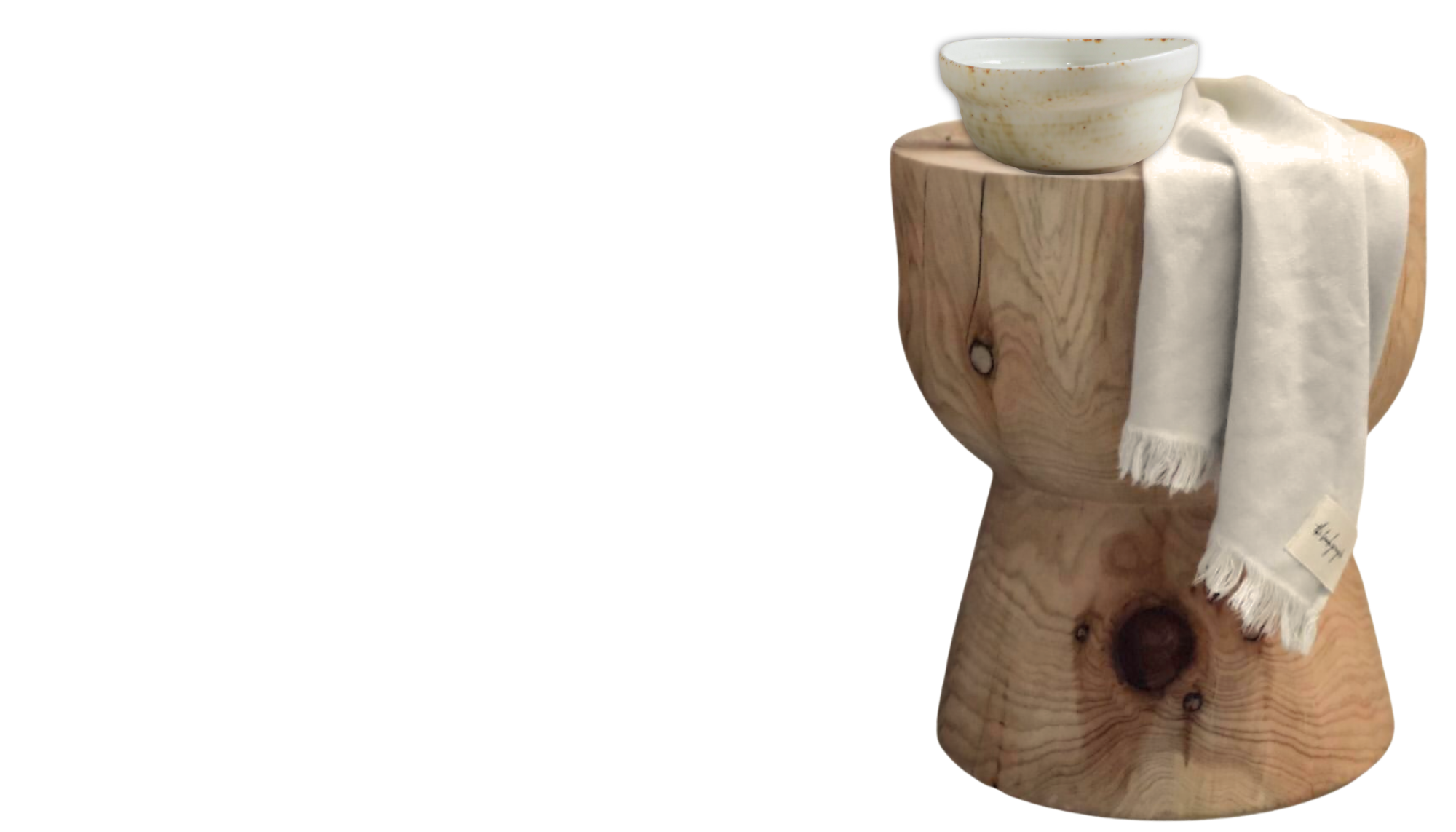 Taj Mahal quartzite-look porcelain tiles featuring soft cream tones and delicate veining, styled with a wooden side table, ceramic bowl and draped ivory linen.  Copy alt text