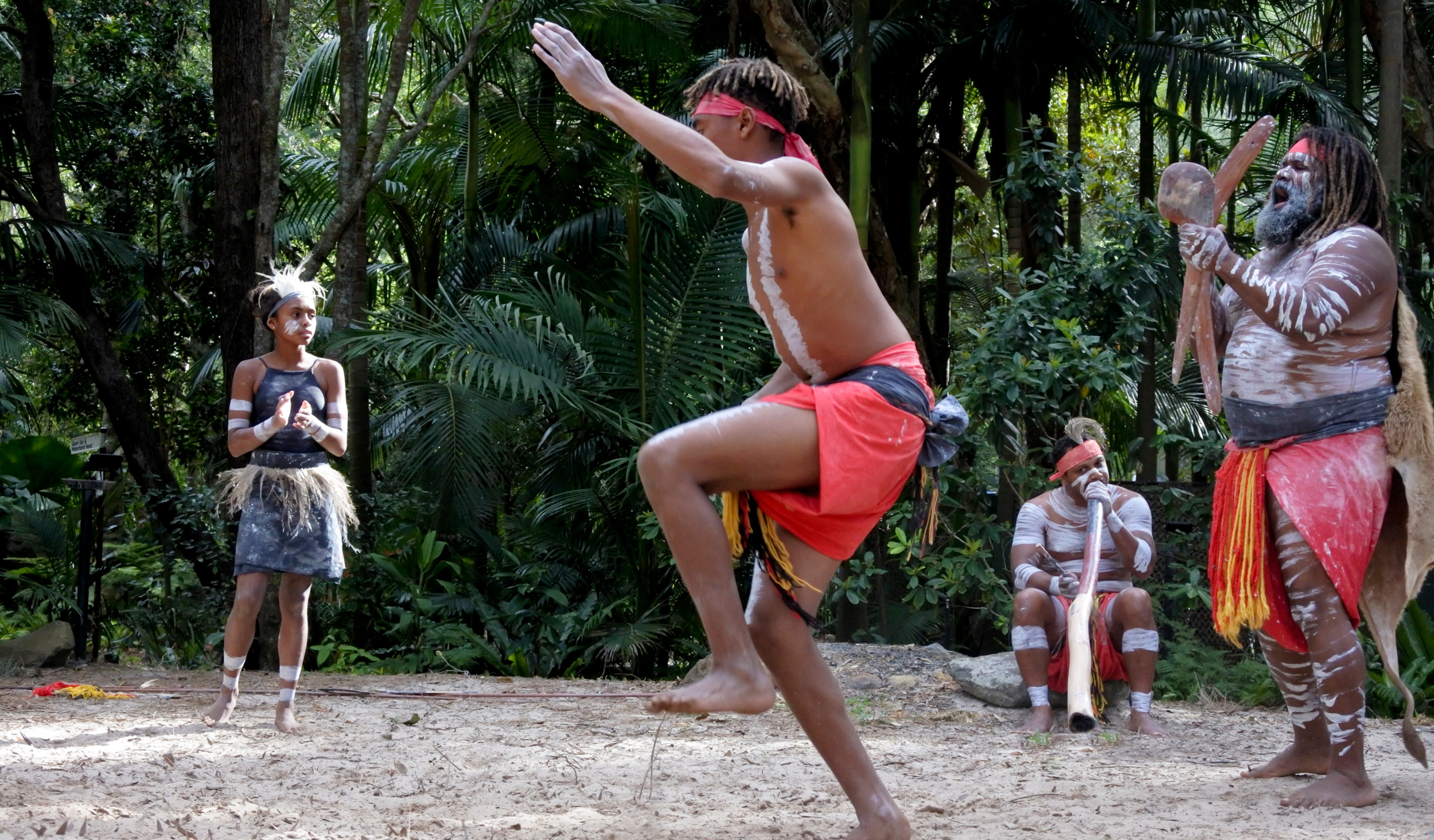 Aboriginal boy dancing with Aboriginal girl in the background