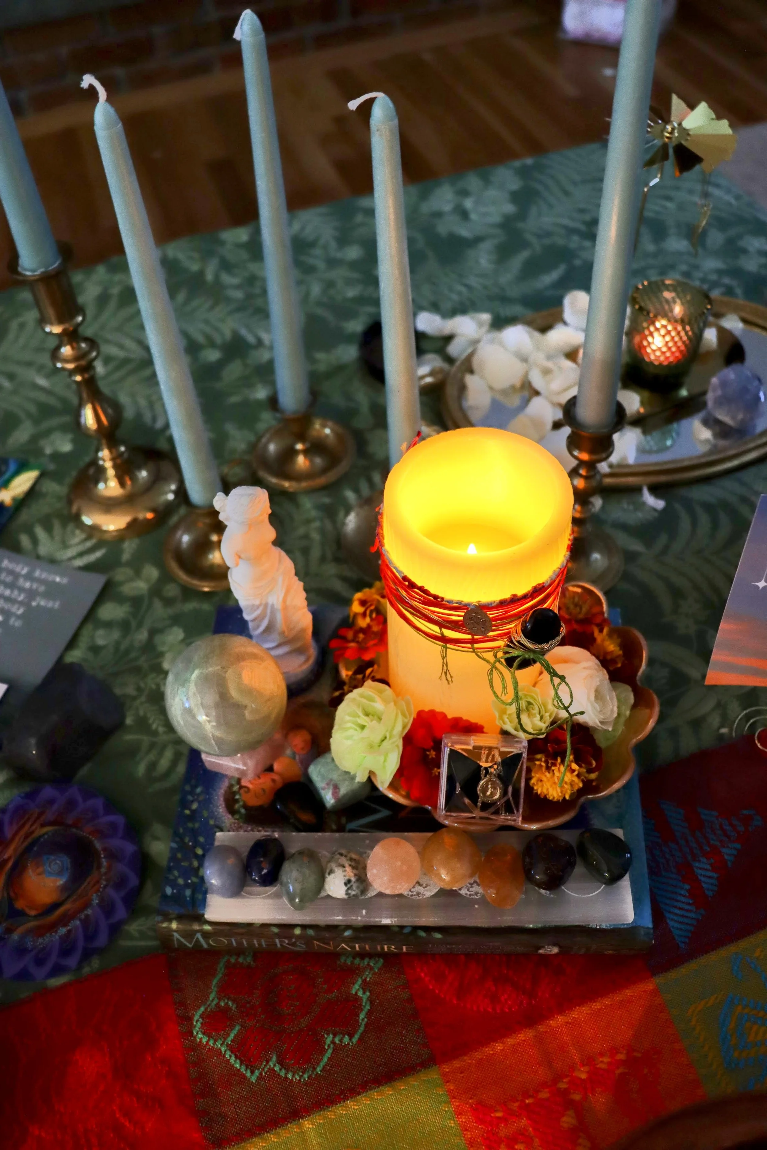 Every altar is customized - here is a glimpse of one. The centerpiece is a beautifully adorned birth blessing candle for mama.