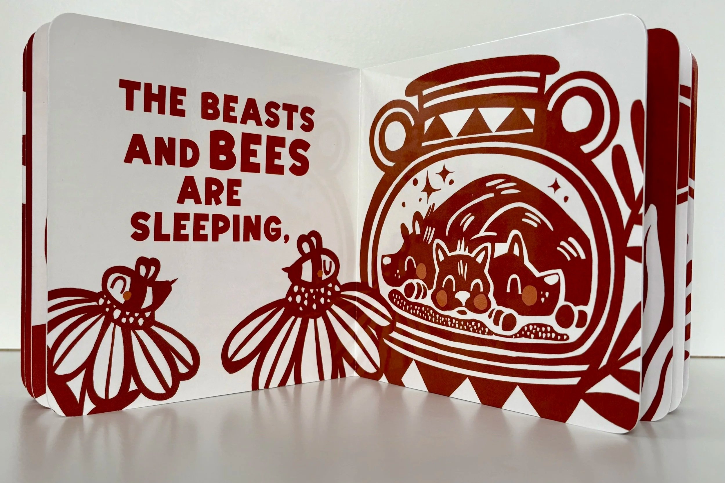 Stylized illustration of bees and flowers next to a red-figure vase with illustration of sleeping dogs.