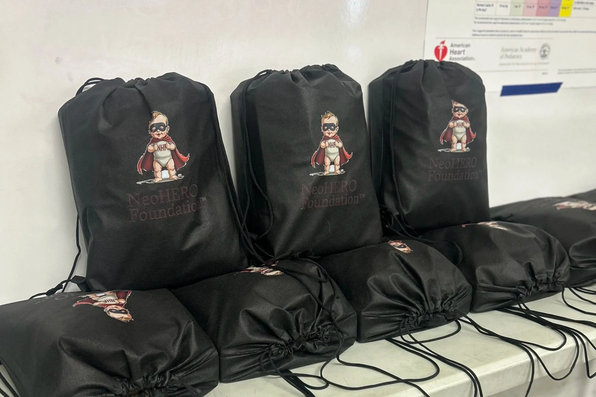 Medical equipment for infant respiratory care, including a TransWARMER infant transport mattress, resuscitation mask, nasogastric tube, and various straps and tubing.