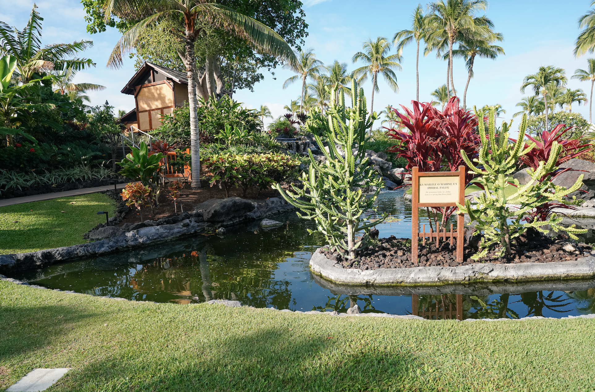 The Spa Without Walls hale tucked into tropical gardens with a koi pond at the Fairmont Orchid