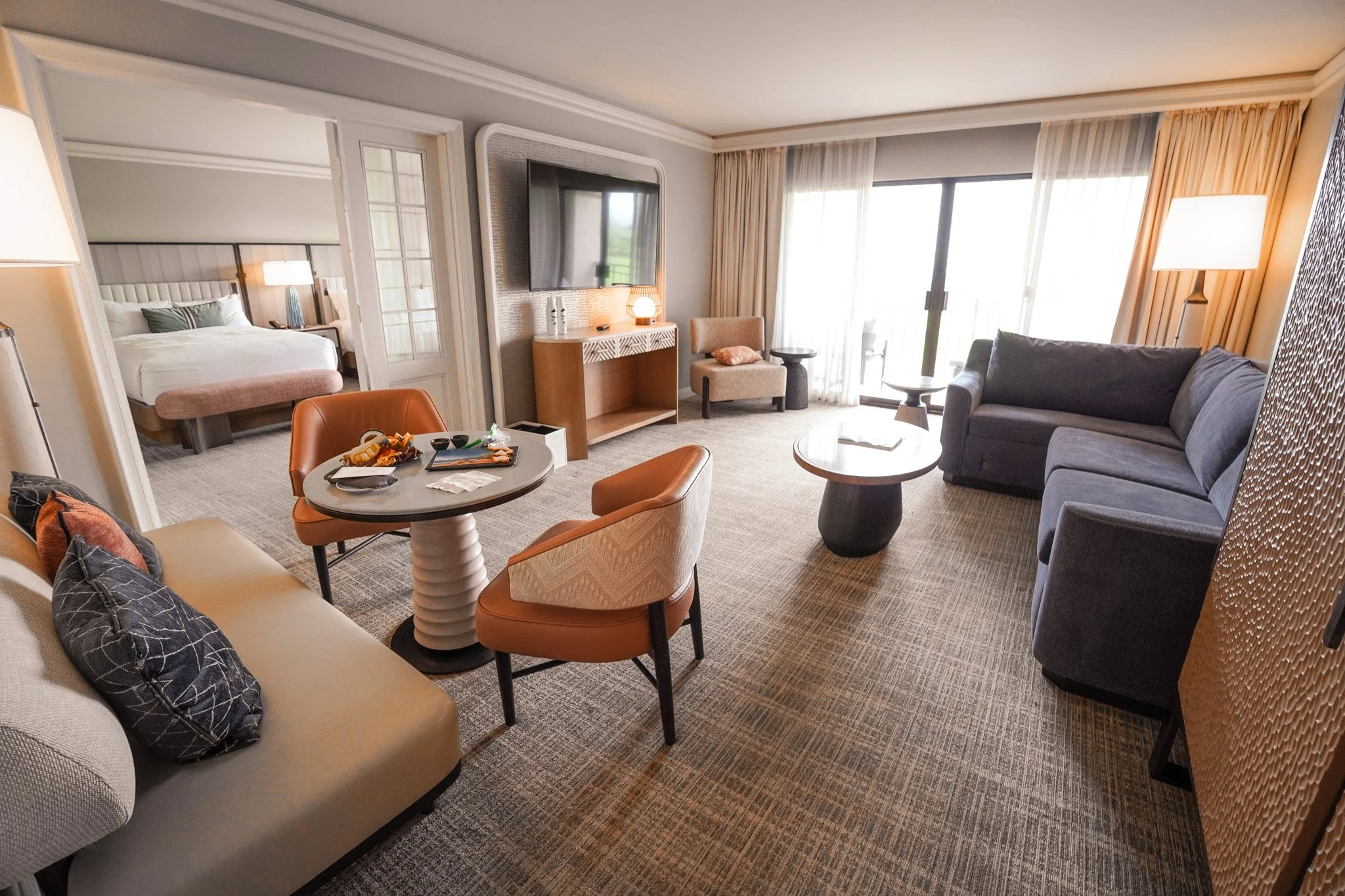 Spacious suite living room at the Fairmont Orchid with seating areas and a view into the bedroom