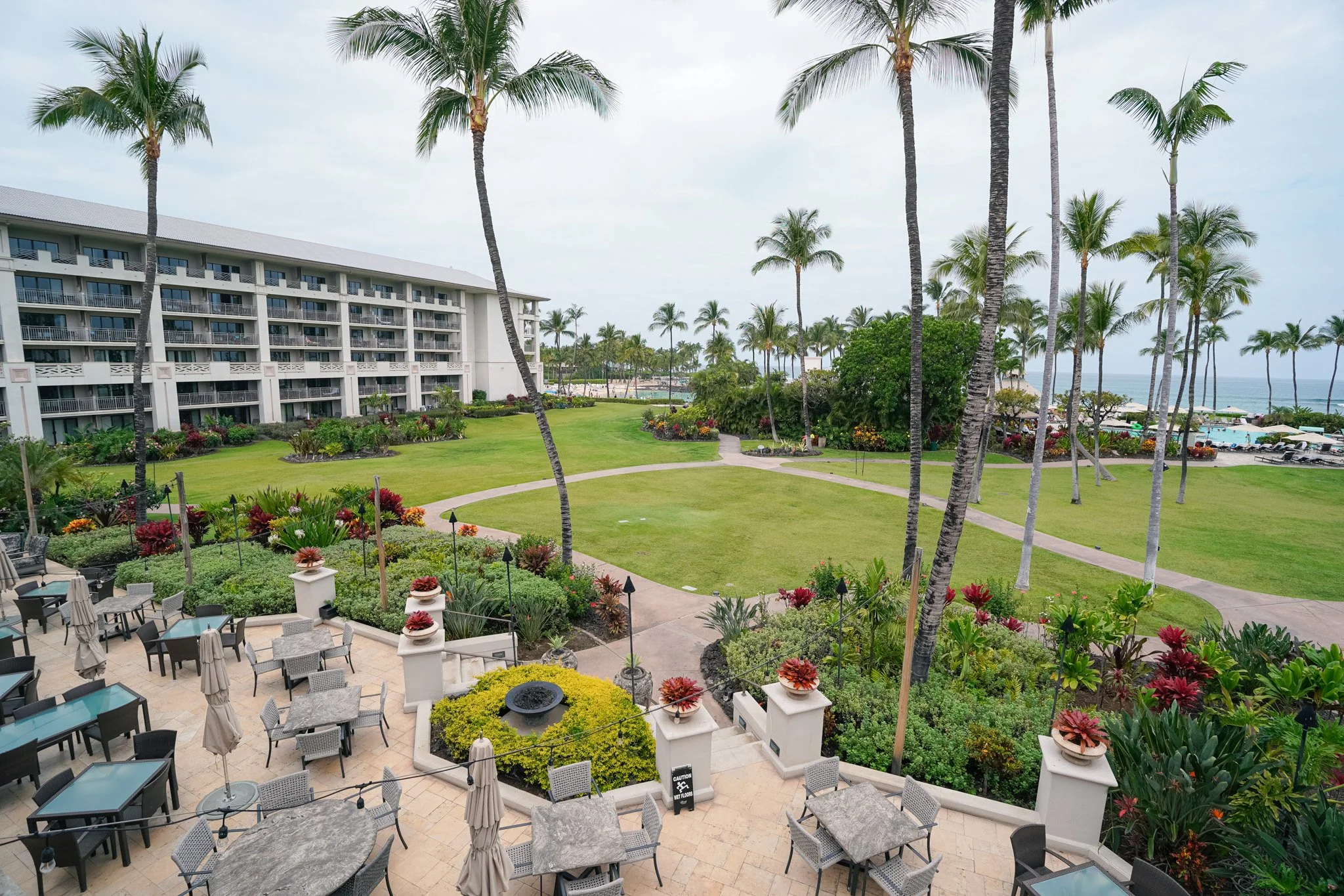 Aerial view of the Fairmont Orchid resort grounds, pool, and palm trees on the Kohala Coast