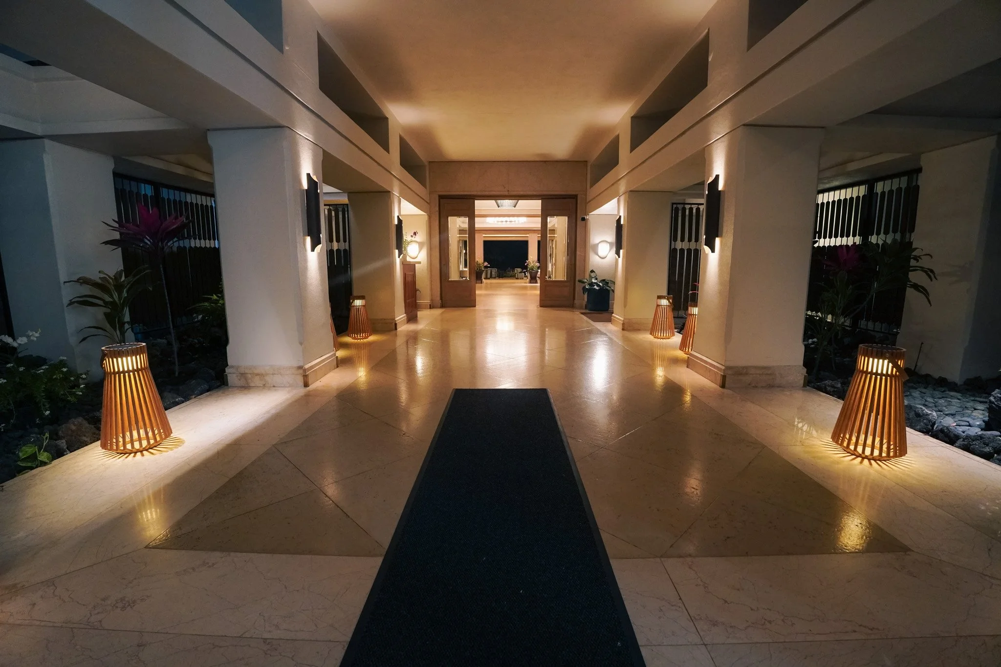 Fairmont Orchid lobby breezeway at night with warm lantern lighting