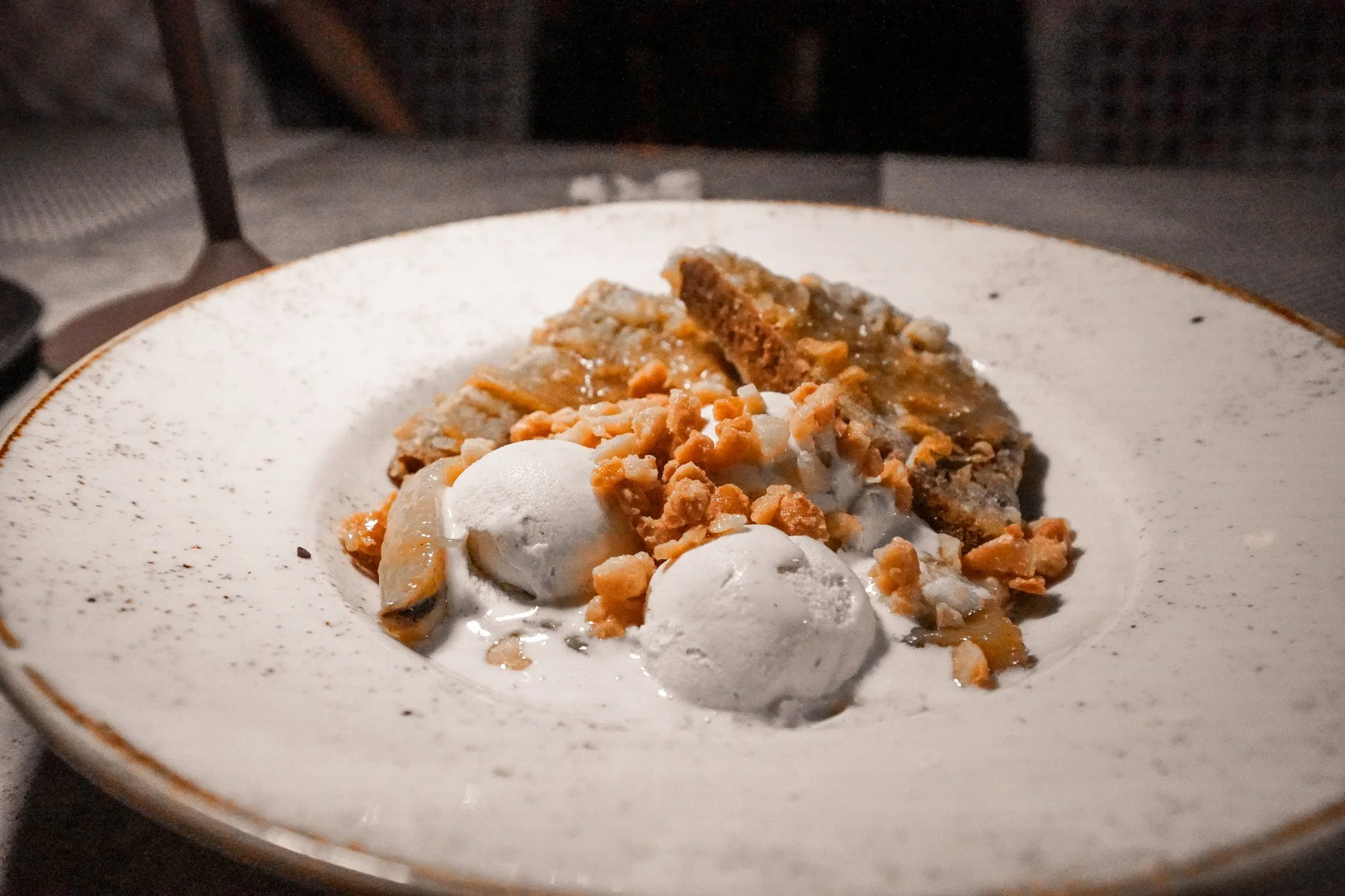 Warm bread pudding dessert with two scoops of ice cream at Binchotan