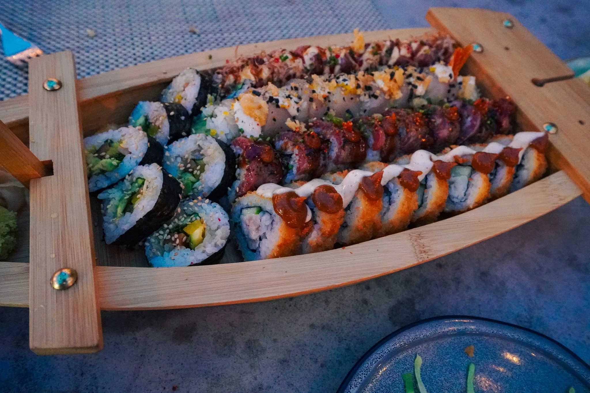 A sushi roll platter at Binchotan with specialty rolls and a traditional cucumber roll