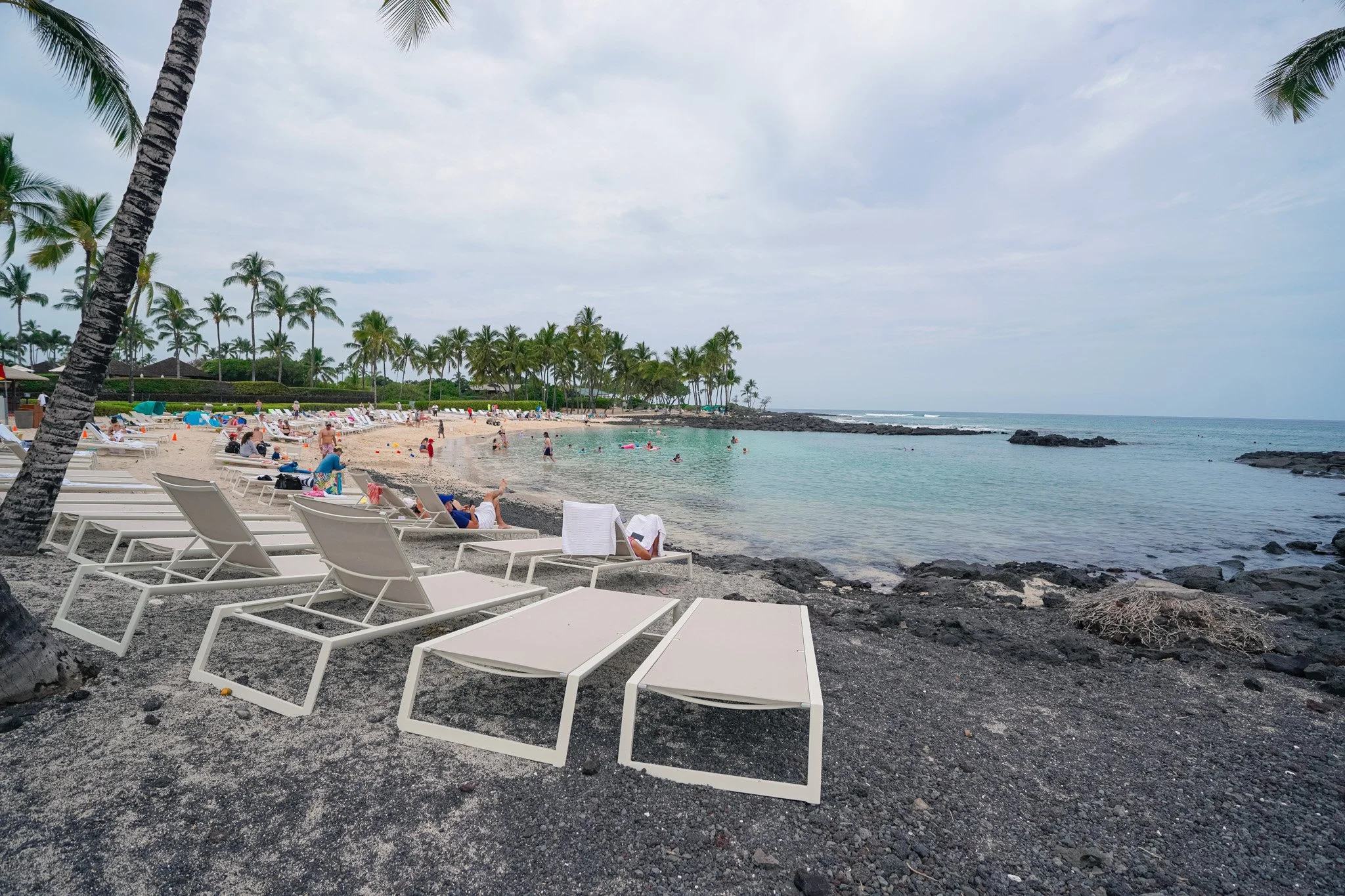The Fairmont Orchid private lagoon and beach area with lounge chairs and turquoise water