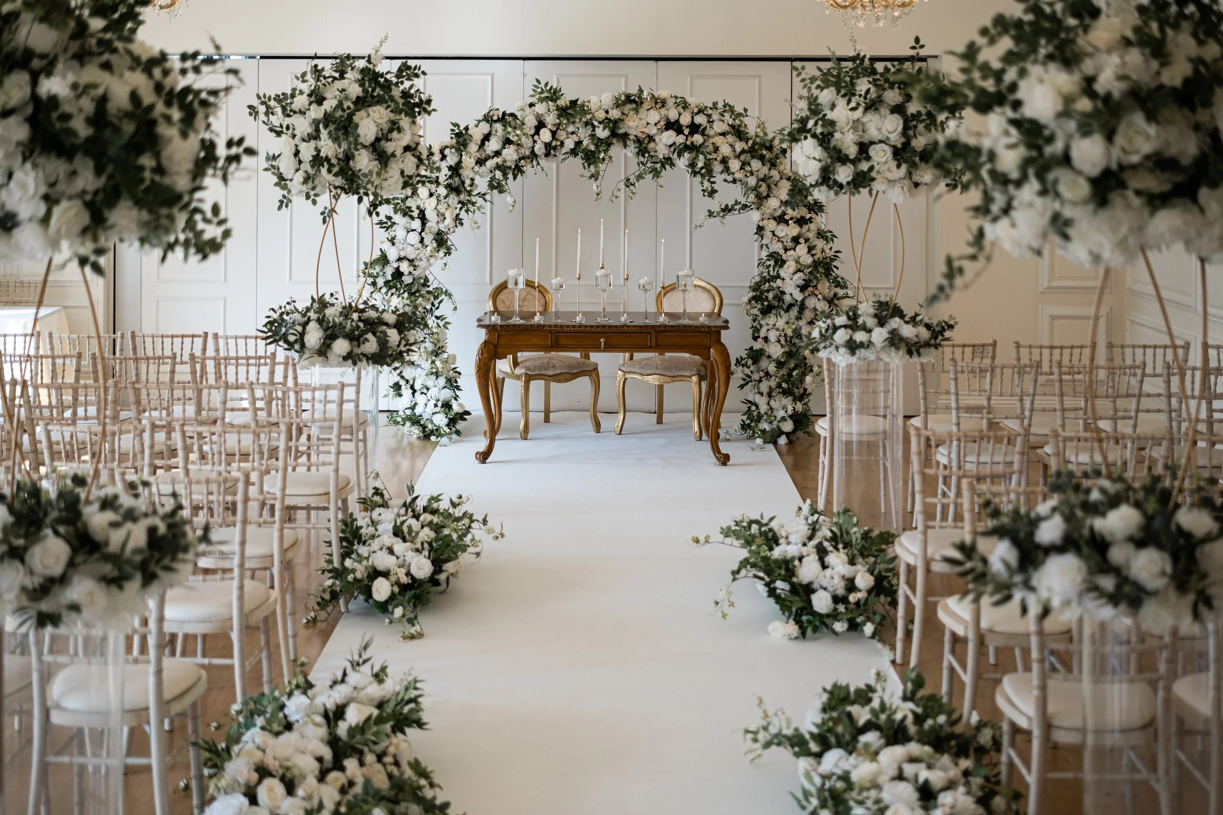 Aisle wedding styling at West Tower, Lancashire. using green and white florals and a statement floral arch.
