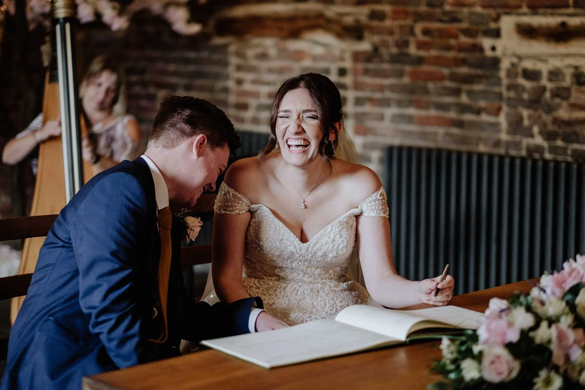 a picture of a bride and groom laughing on thier wedding day because they booked with Liverpool's Number one wedding shop the Alexander Wedding Co