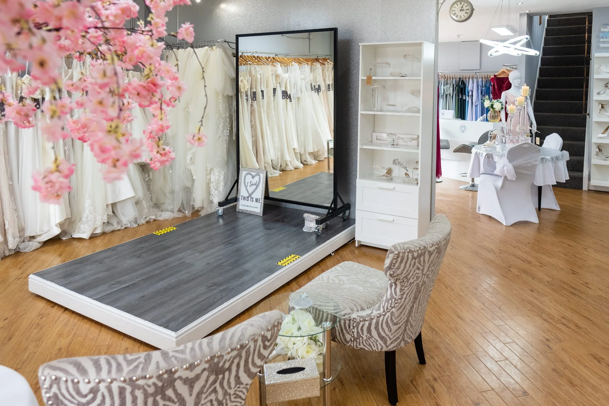 the inside of our bridal boutique in Liverpool showing the cat walk and wedding dresses hanging.