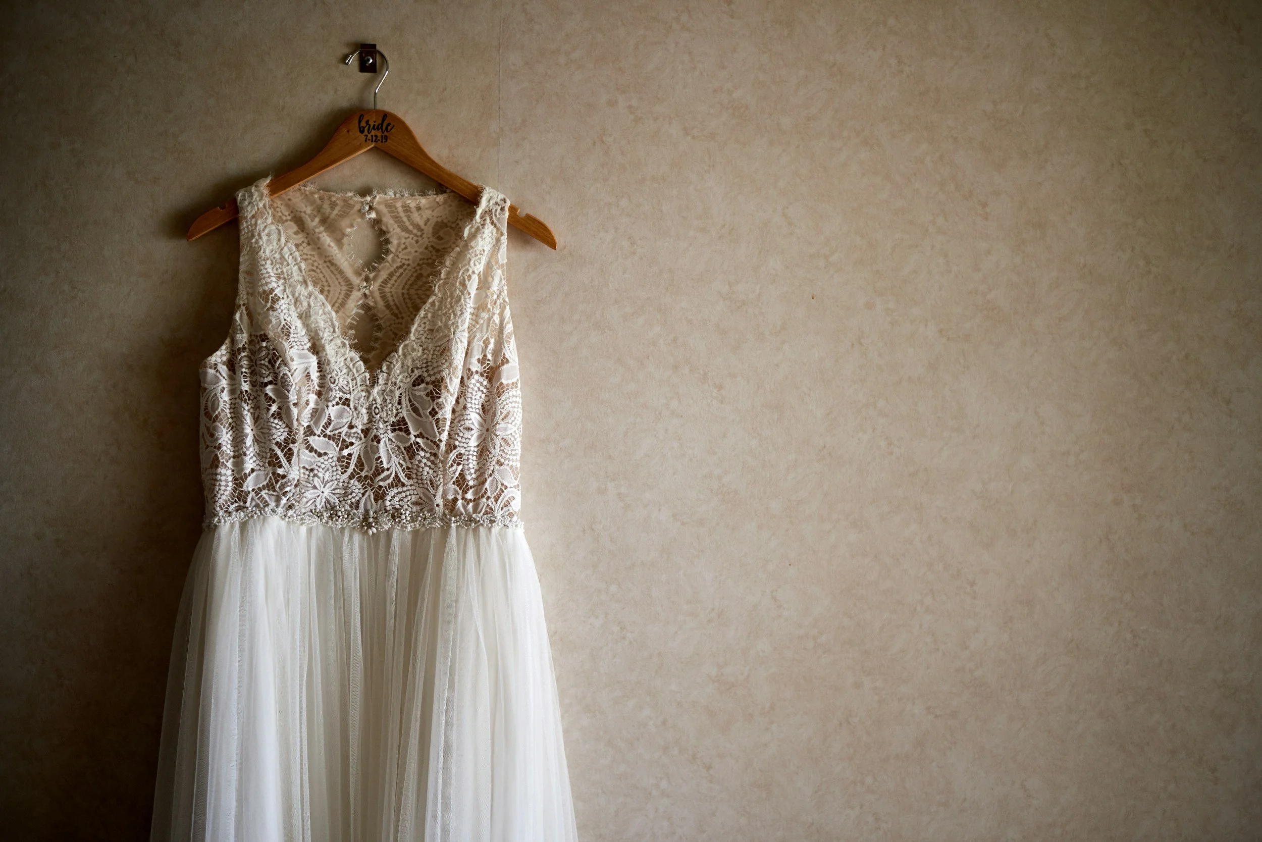 a wedding dress hanging on the wall in our bridal boutique in Liverpool