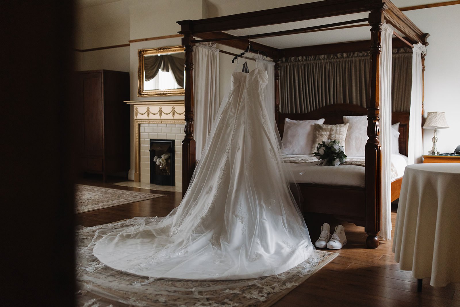 The brides dress hanging on the four poster bed in the West Tower bridal suite.