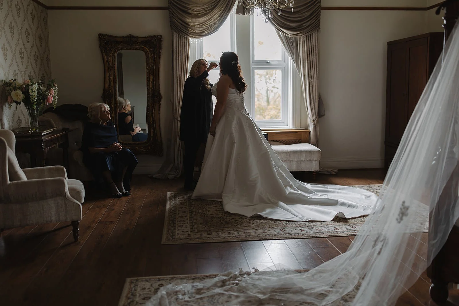 A bride having the finishing touches made in the bridal suite at west tower.