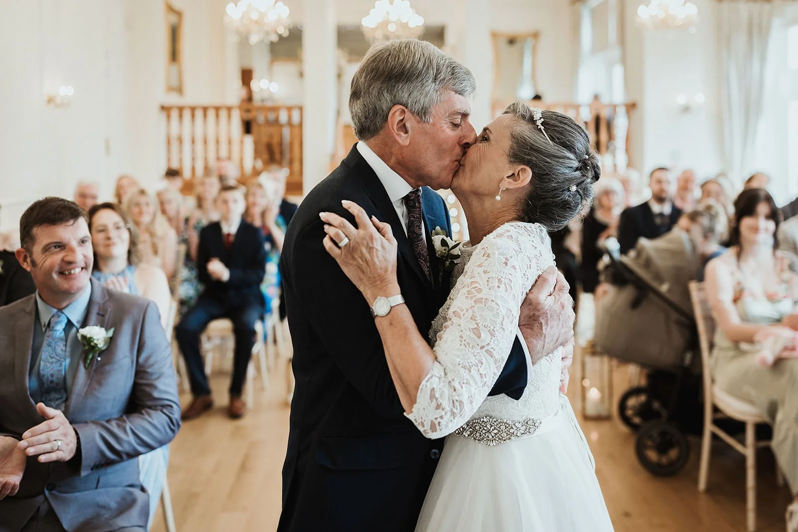 A wedding photograph showing a natural wedding photograph of a couple kissing during their ceremony at west tower.