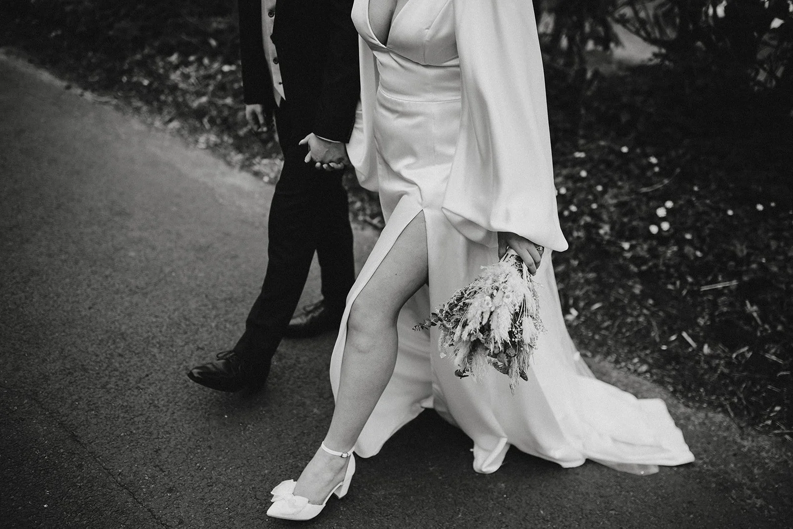 bride and groom walking across the grounds at west Tower.