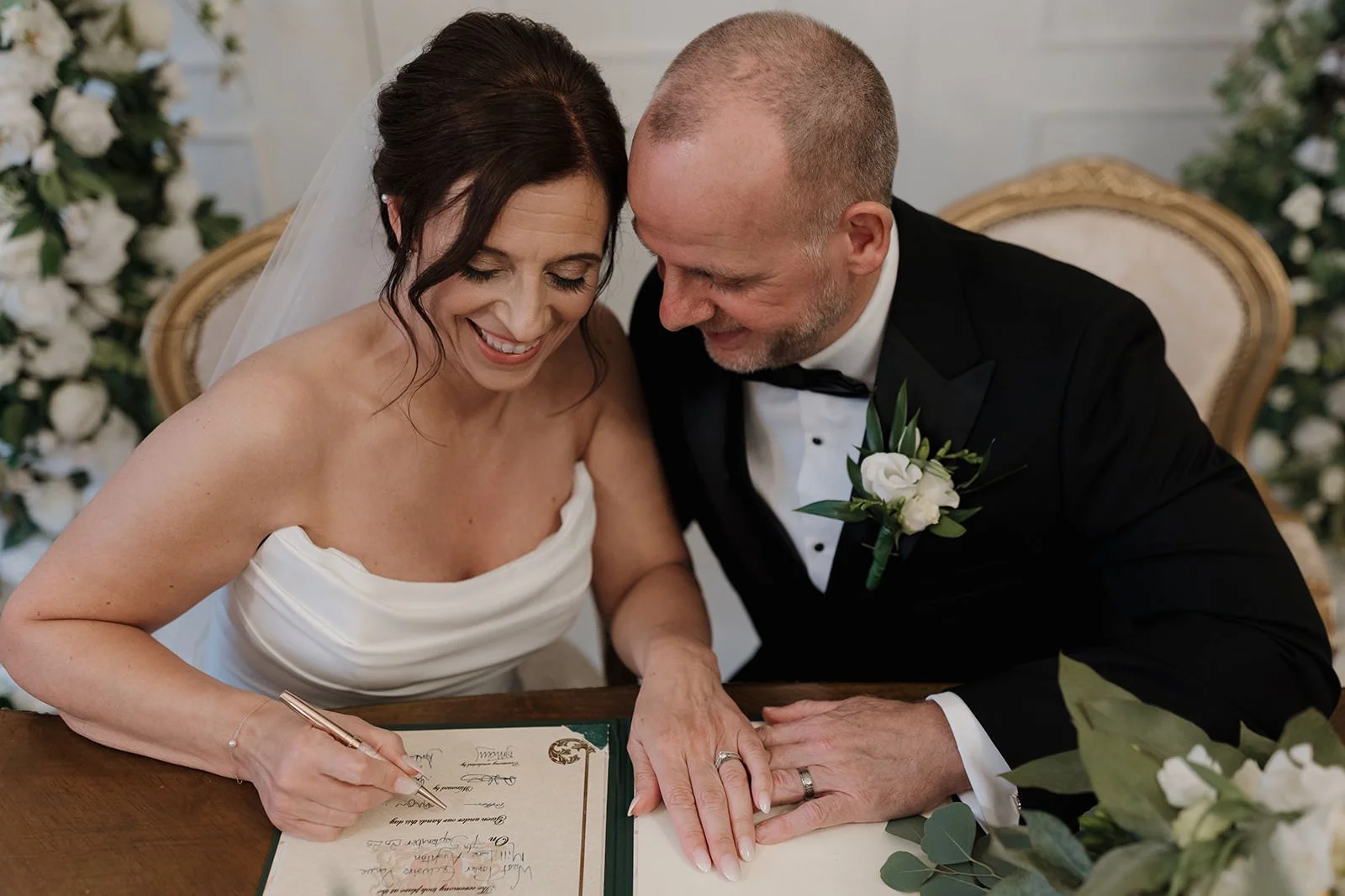 bride and grom signing the marriage certificate after their beautiful wedding ceremony at West Tower, Lancashire, Aughton