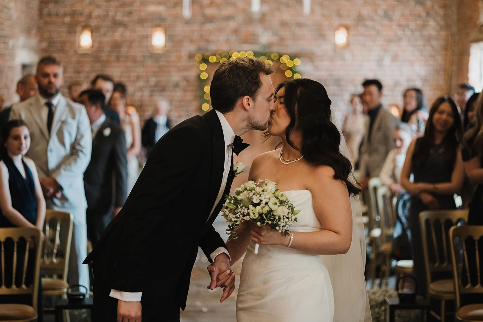 Meols Hall Wedding Photography showing the married couple kissing during the wedding ceremony.