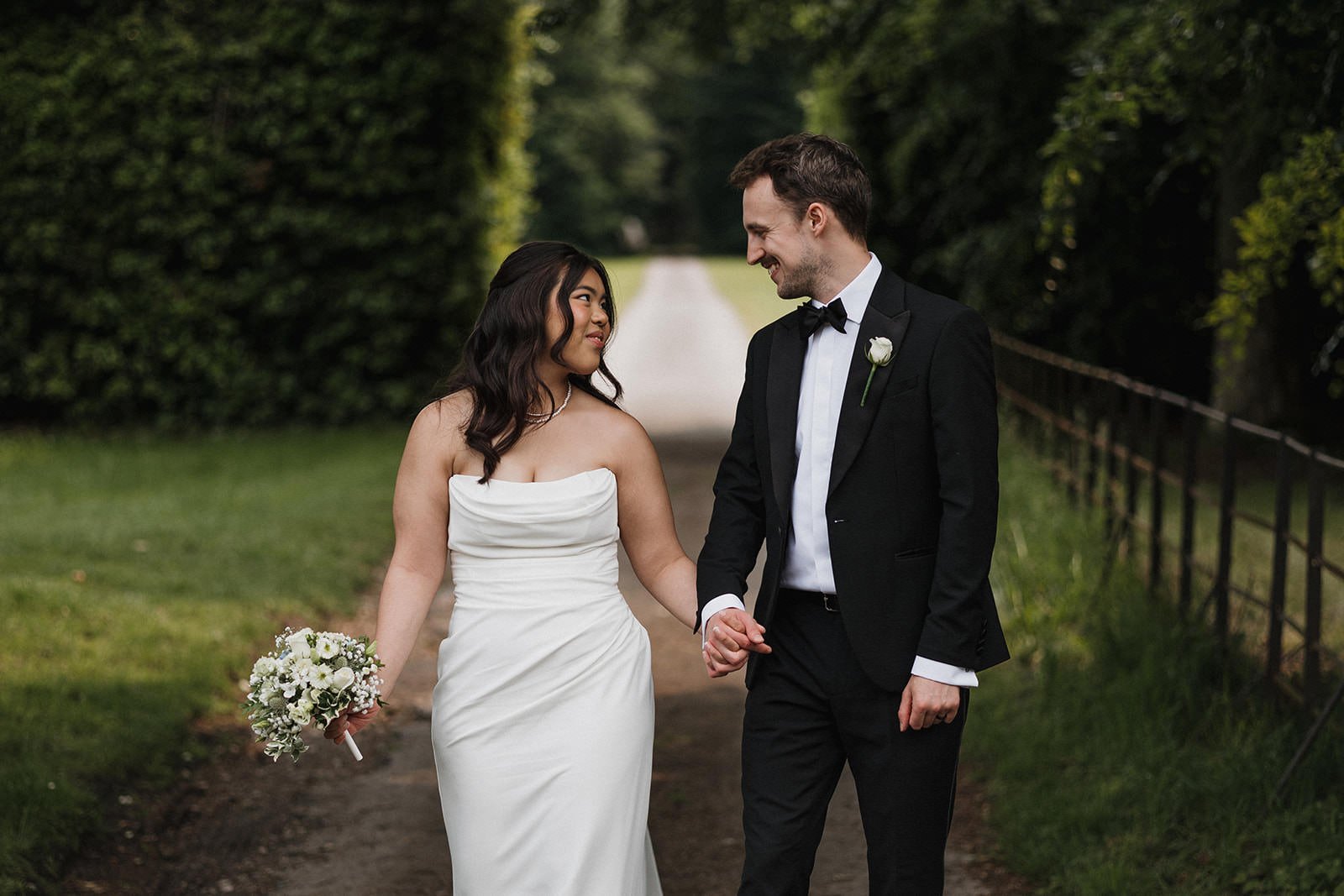 Meols Hall Wedding Photography showing the couple walking and smiling on the grounds of Meols Hall.