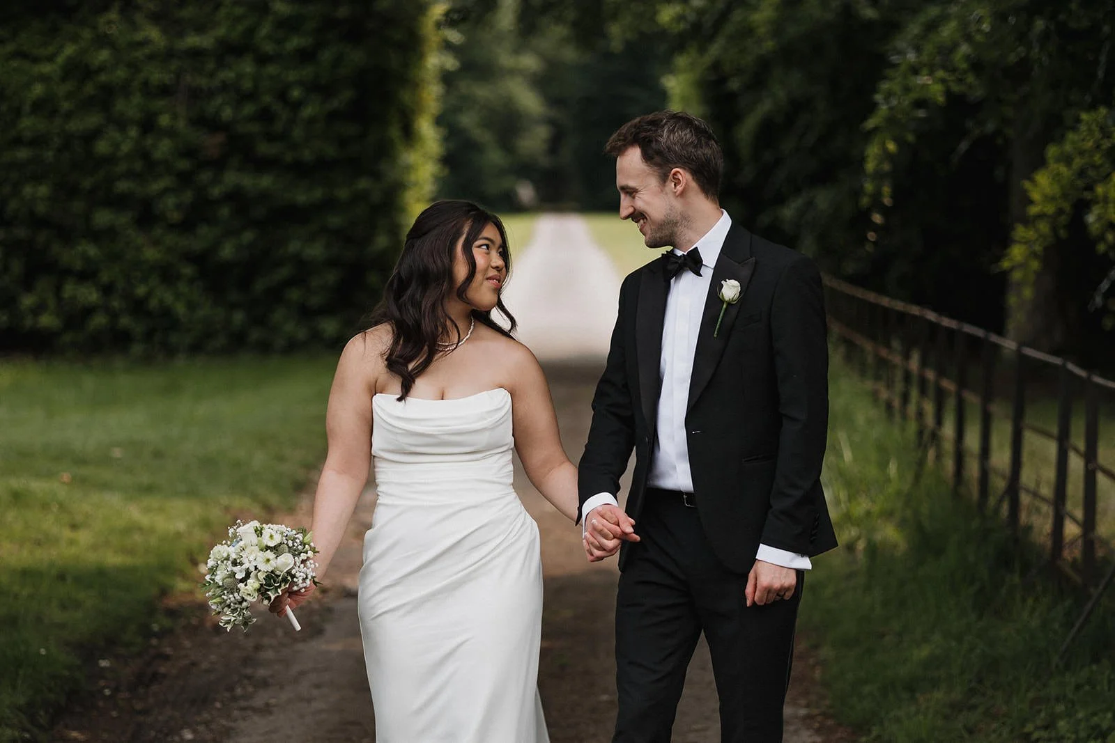 Meols Hall Wedding Photography showing the couple walking and smiling on the grounds of Meols Hall.