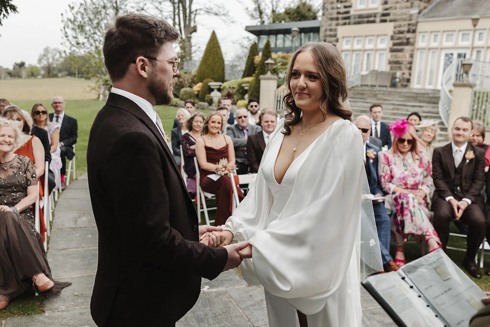 A wedding photograph showing a bride and groom enjoying their outdoor ceremony at west tower.