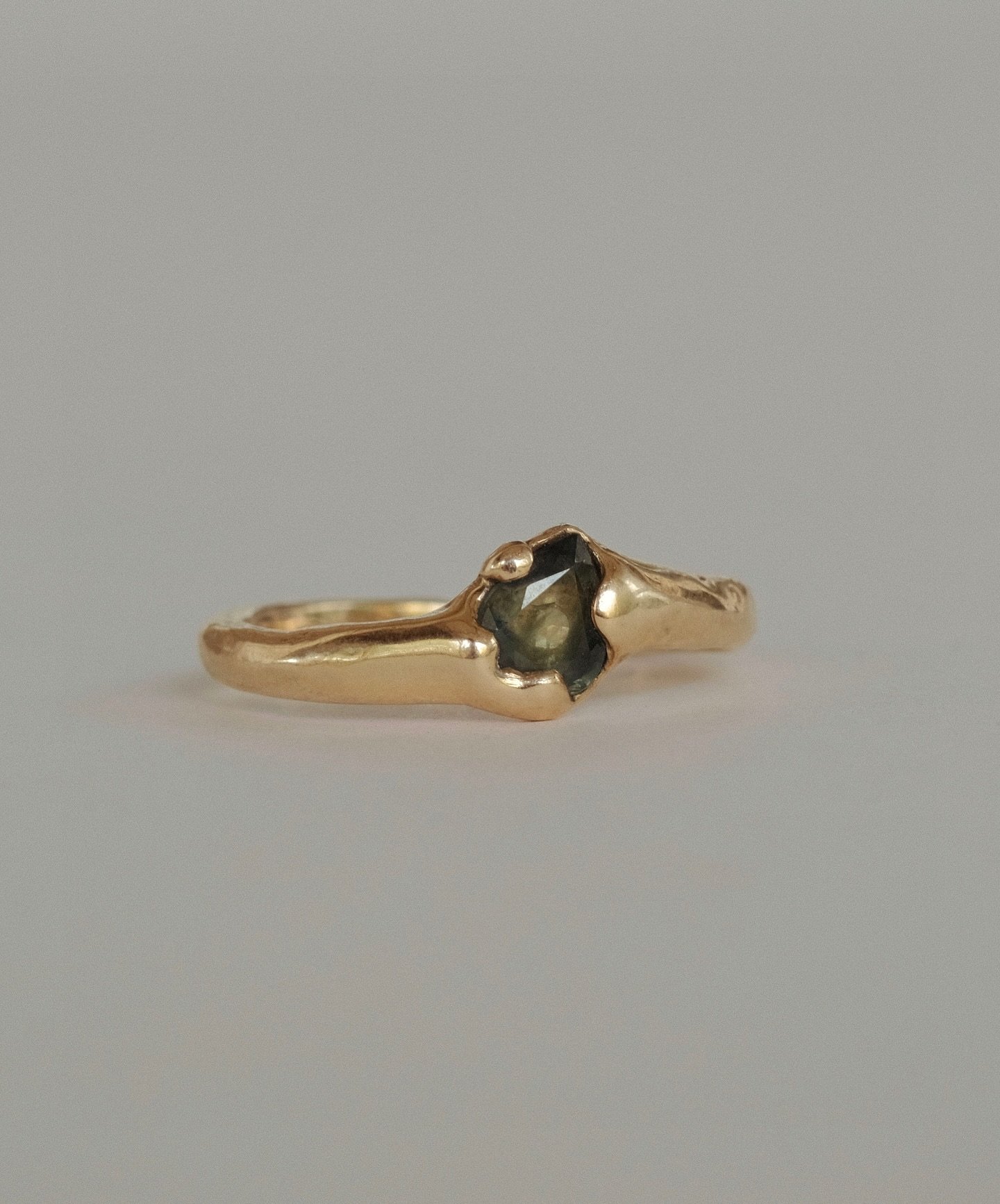Gold Tide Ring - organic molten 9k gold set with a pear shaped parti sapphire. 

Available in size M-N (UK/AUS) / 6.75 (US/CAN) 🤎