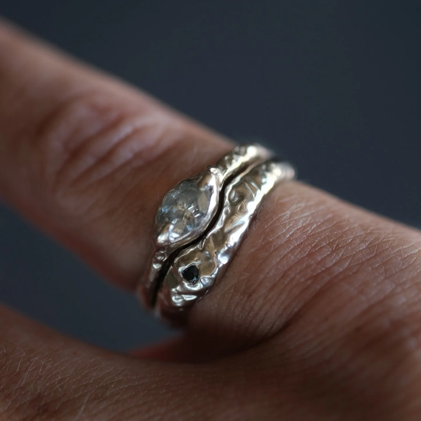Loving the rawness of this organic 14k white gold band with black sapphire to hug my client&rsquo;s engagement ring 🤍