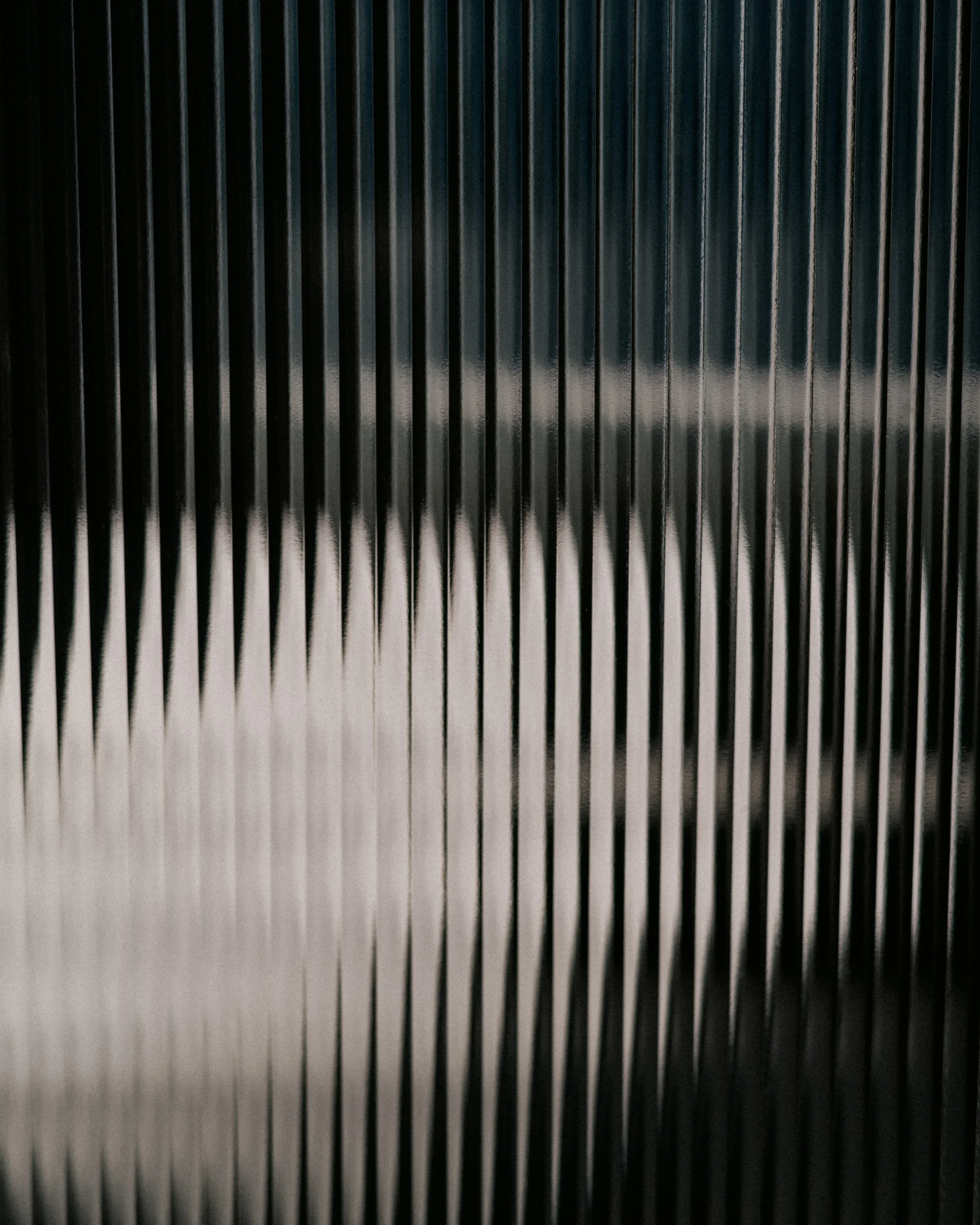 Close-up of a metallic ribbed surface, possibly part of an industrial machine or equipment.