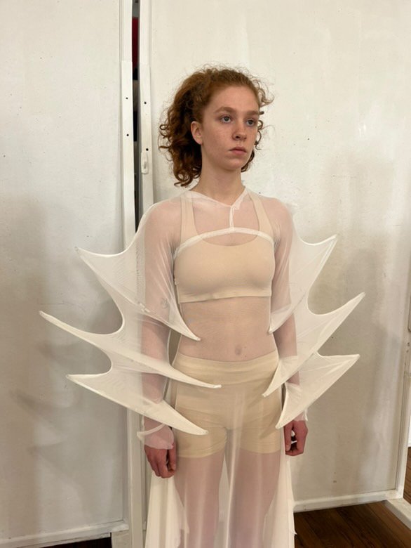 Prototypes played a crucial role in learning how to construct garments using acrylic. The garments were first made with a sheer stretch mesh/jersey fabric, and altered according to a series of model fittings.