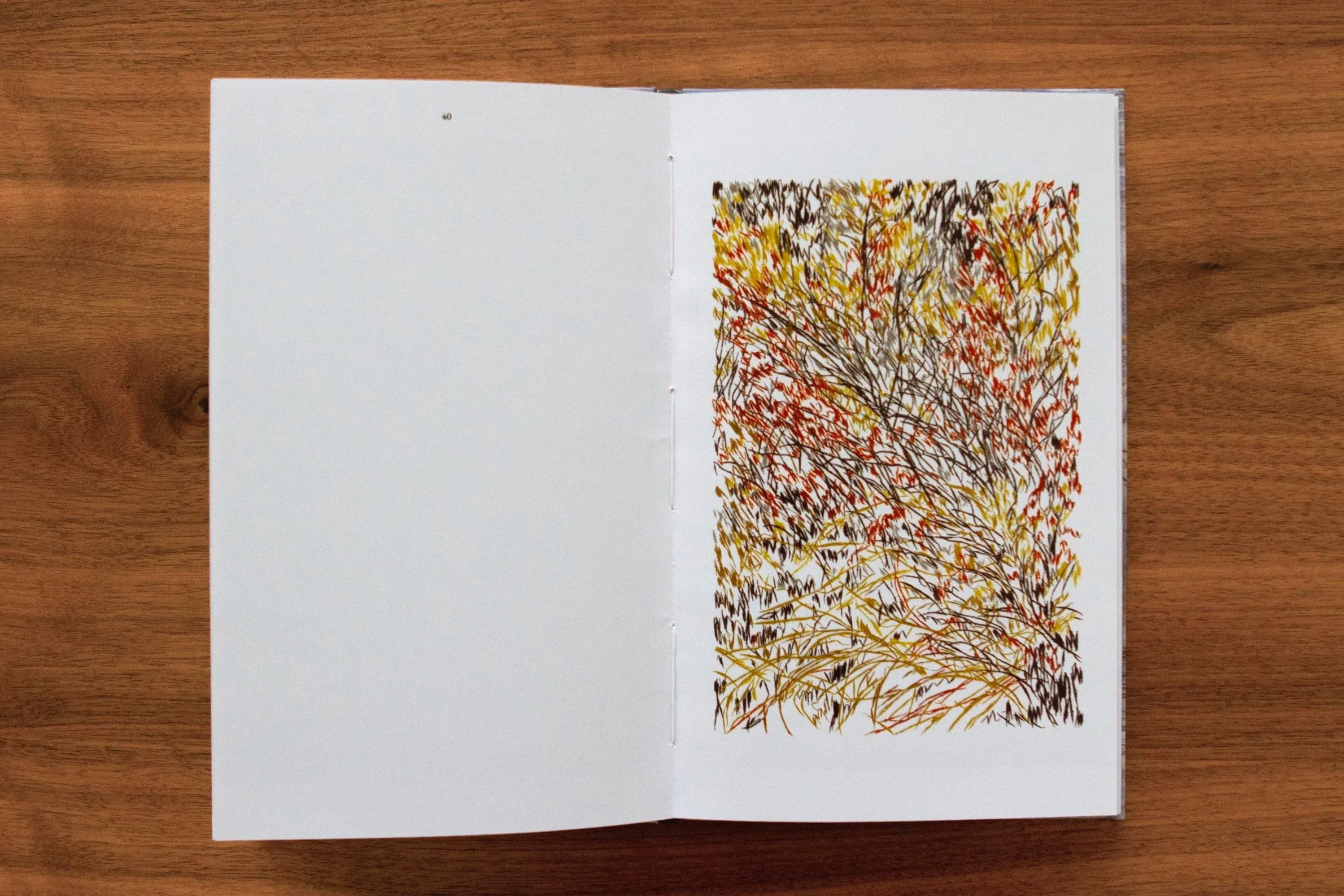Open sketchbook on a wooden surface, displaying an abstract, colorful drawing with zigzag and scribble patterns in yellow, red, brown, and black. Artist Book  María Jesús Valenzuela Vittini. Bordado en papel.