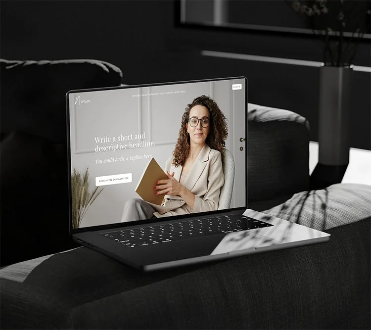 A laptop on a dark sofa with a website for booking a consultation displayed on the screen.