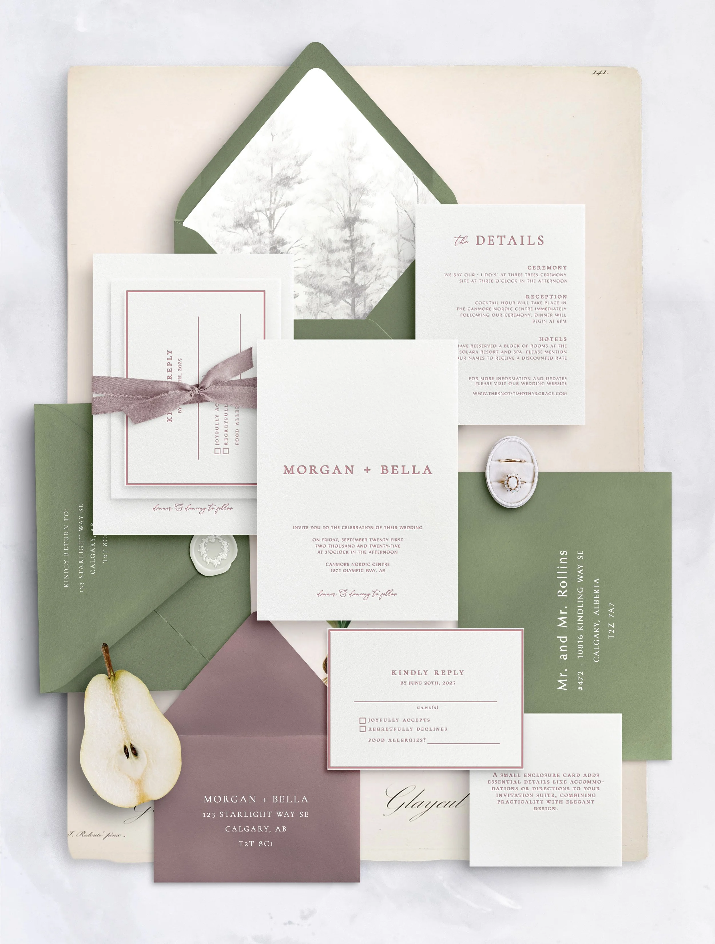 A flat lay of wedding invitations, envelopes, RSVP card, ring box, and a pear on a marble surface.