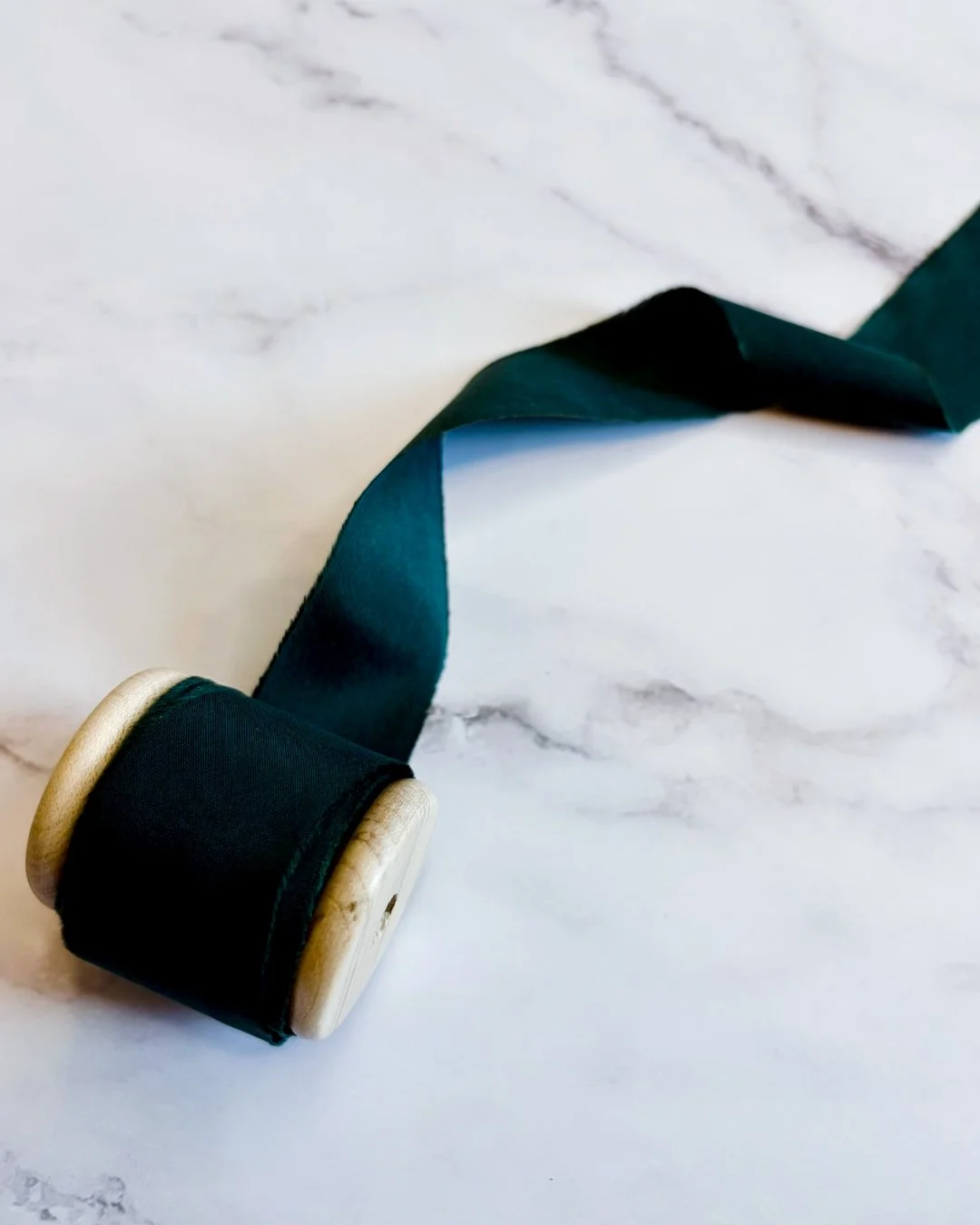 Deep emerald silk ribbon: rich, moody, and just polished enough.
I love using ribbon like this when a suite needs a little more depth. It adds softness, movement and contrast without competing with the stationery itself.

Sometimes the smallest detai