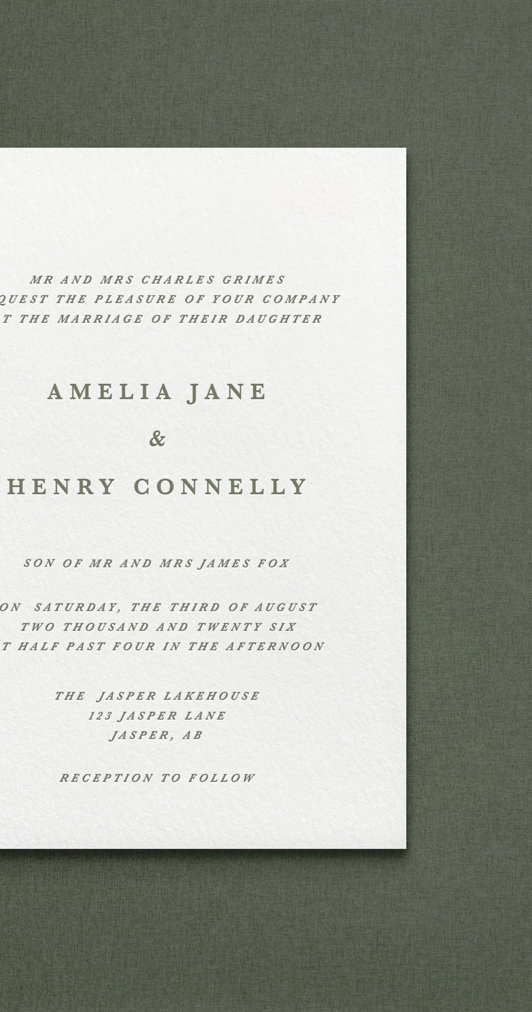 Wedding invitation card with elegant font on textured paper, with green background.