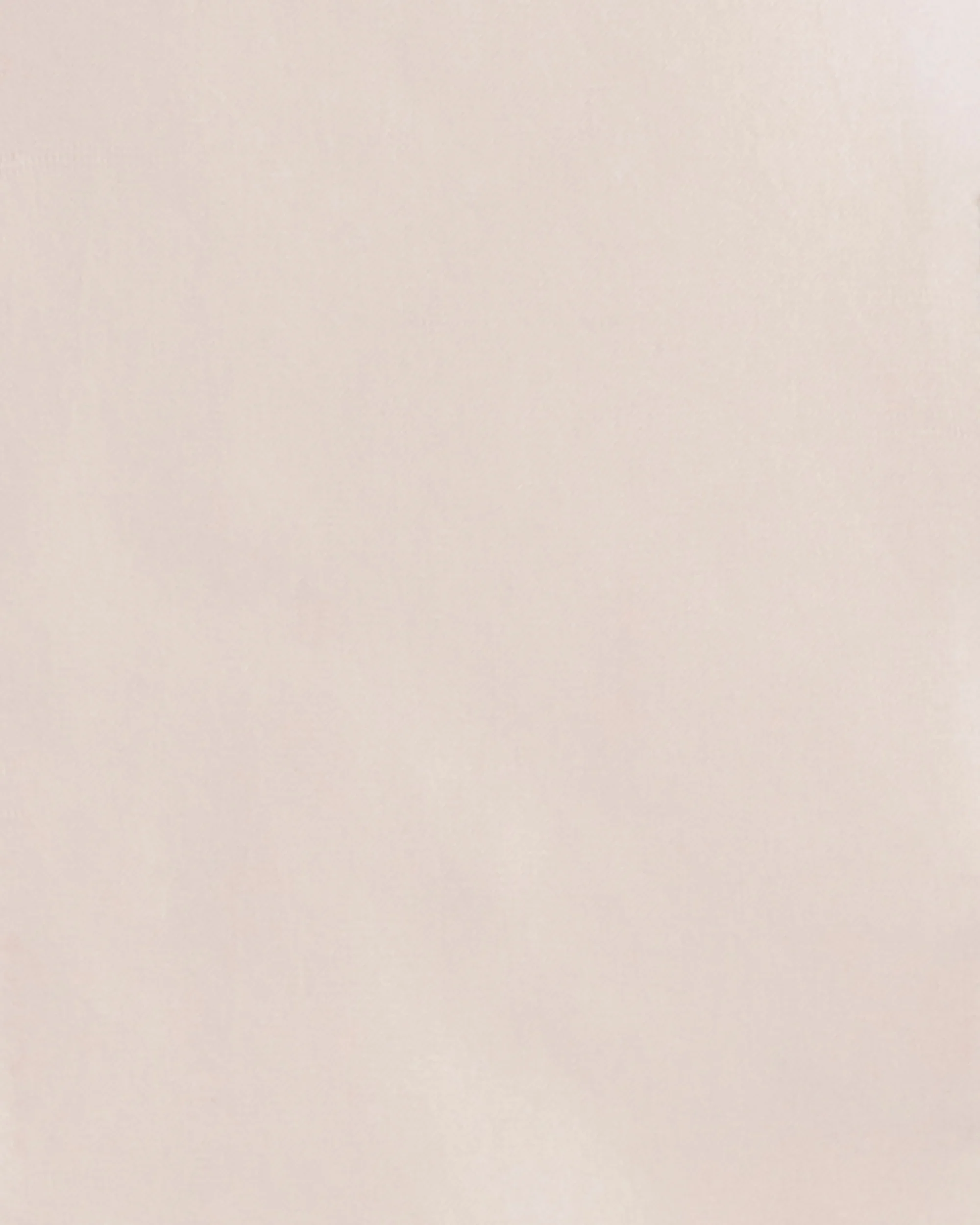 The image shows a plain, light-colored wall with no distinct features or objects.
