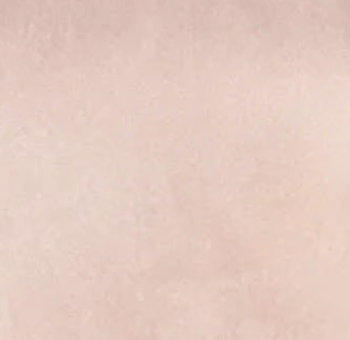 Close-up of a plain, light pink surface.