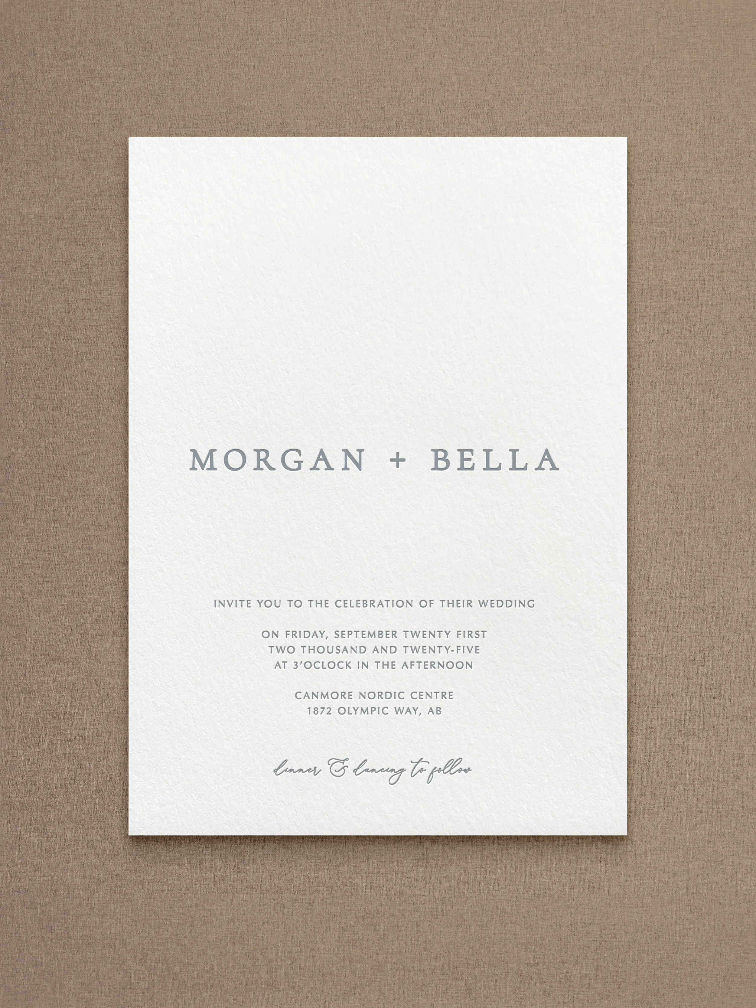 Wedding invitation card with text in a minimalist style on a textured background.