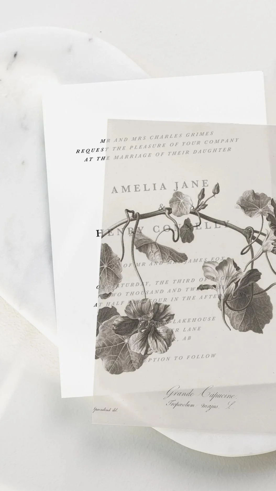 Wedding invitation card featuring a botanical illustration of ivy leaves and flowers.