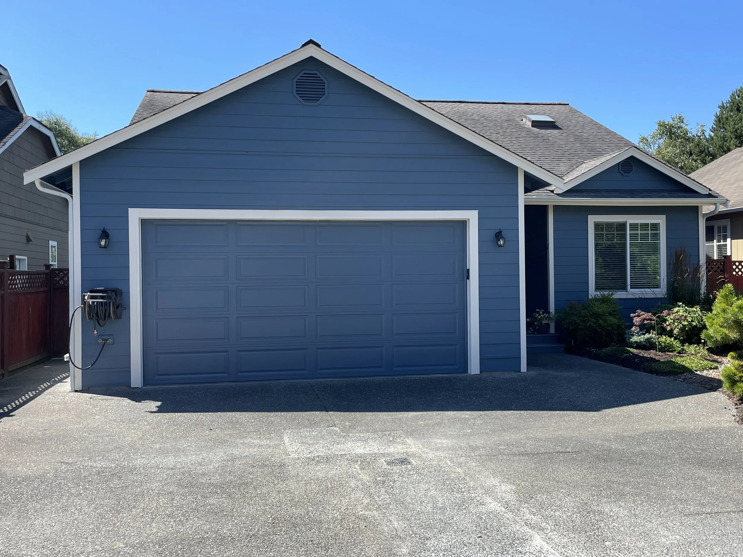 Skagit Home Repairs LLC team providing exterior residential painting services, updating a home with a vibrant new color
