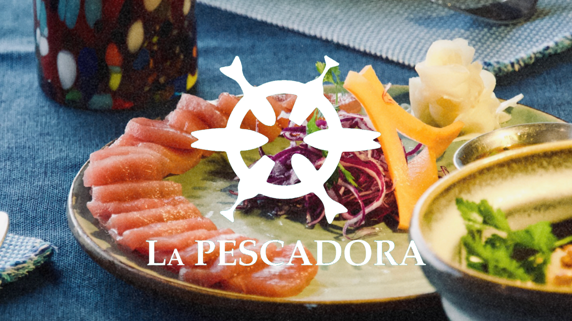 Sashimi platter with sliced tuna, carrot garnish, and pickled ginger on a green plate with "La Pescadora" logo overlay.