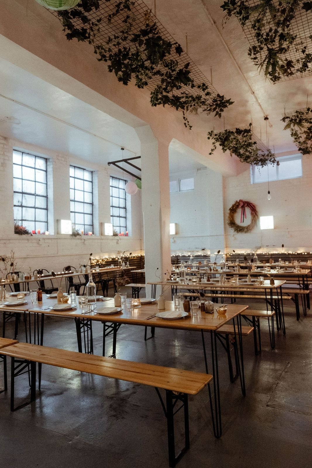 Warehouse space showing tables and chairs set out for a wedding at The Hide events venue, Sheffield.