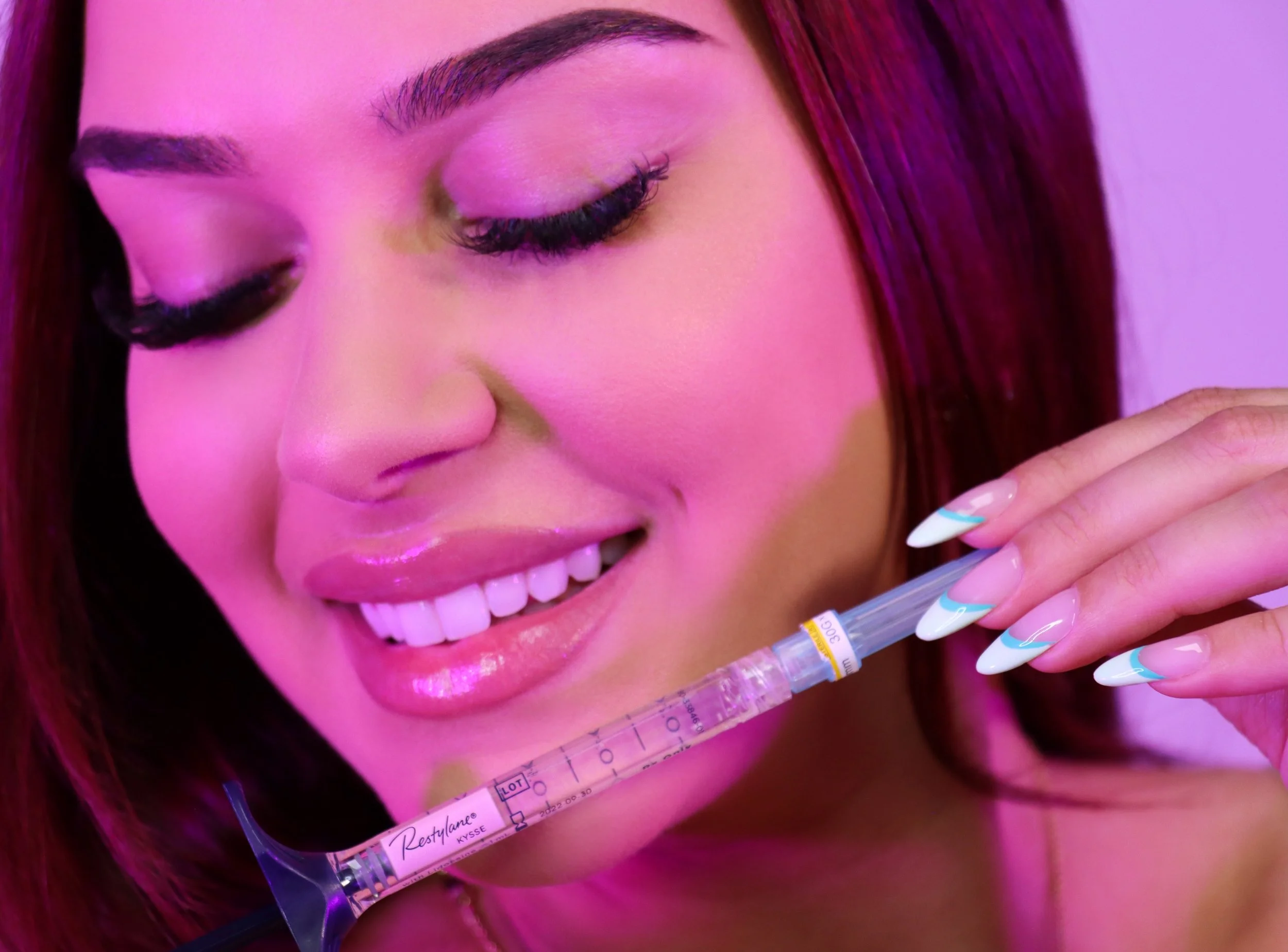 Aesthetic medicine photography by Jessica Levi featuring a Restylane Kysse syringe during a lip enhancement procedure.