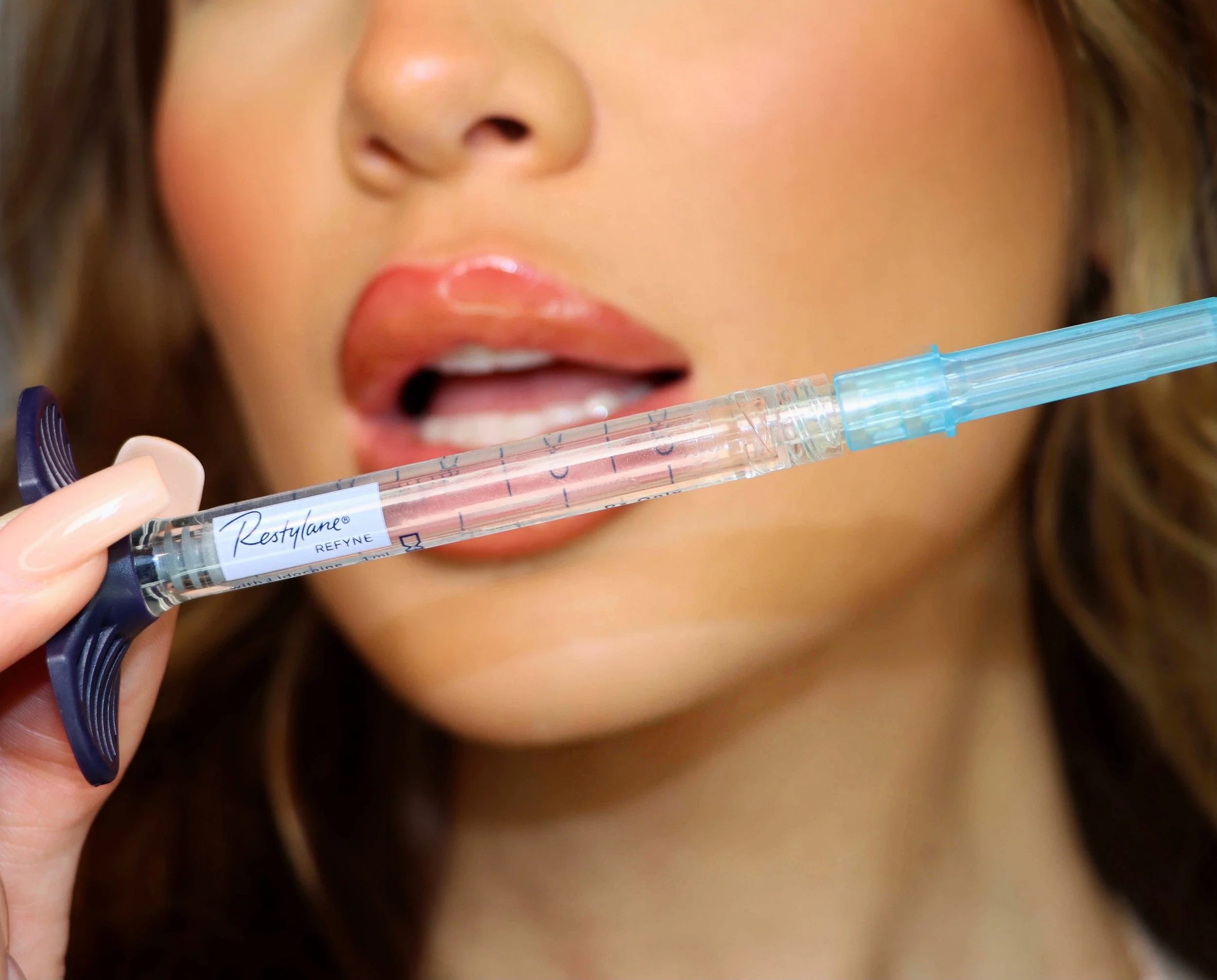 Detail shot of lip filler injection using Restylane Refyne, captured by Jessica Levi for a cosmetic clinic’s branding.