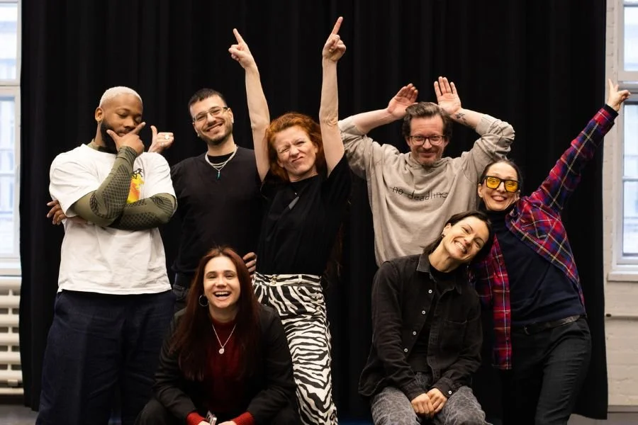 Group of smiling people take a group selfie